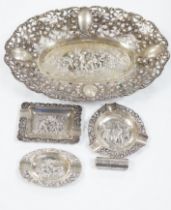 A German pierced 800 white metal oval dish, 28.4cm, three Dutch white metal ashtrays and an 835