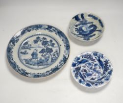 An 18th century Chinese export blue and white dish together with two others, largest 26cm