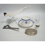 Concorde memorabilia comprising four British Airways glass tots, a pair of plated cased clothes