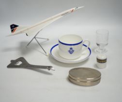 Concorde memorabilia comprising four British Airways glass tots, a pair of plated cased clothes