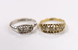 An early 20th century 18ct and claw set graduated old cut diamond half hoop ring, size N and an