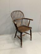 A mid 19th century Windsor elm and beech comb back elbow chair, width 62cm, depth 38cm, height 98cm