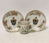A Chinese armorial coffee cup and two saucers, saucers 12cm in diameter
