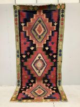 A Kilim geometric polychrome rug, approximately 320 x 140cm