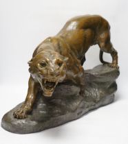 A patinated spelter model of a panther, signed Cartier, approx. 62cm wide