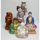 Five Chinese figures of Buddha or Budai, including a hardwood example, largest 38cm high
