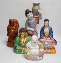 Five Chinese figures of Buddha or Budai, including a hardwood example, largest 38cm high