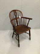 A 19th century yew, elm and beech Windsor elbow chair with crinoline stretcher, width 64cm, depth