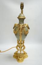 An ormolu mounted ram head table lamp