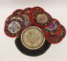 Three sets of six circular Chinese polychrome and gilt thread embroidered mats, a set of four mats