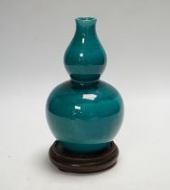 A Chinese turquoise glazed double gourd vase, on stand, 17cm