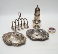 A 1930's silver sugar caster, 16.2cm, a silver five bar toastrack, two silver bonbon dishes and an