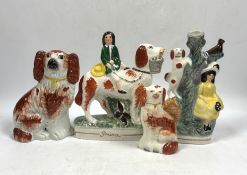 Two Staffordshire spaniels and two pottery groups, largest 19cm high