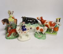 A Victorian Staffordshire cow tureen and cover, and five other Staffordshire figures, largest 18cm