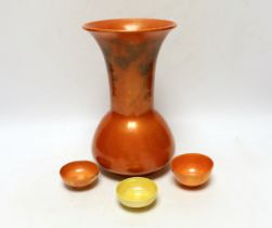 A Ruskin orange glazed vase (a.f) and three similar small bowls by Ruskin and Doulton, vase 23.5cm