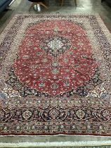 A Kashan red ground carpet, 355 x 240cm