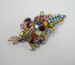 A 9ct and multi gem set floral spray brooch, including zircons, tourmaline and amethyst, by