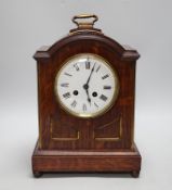 A oak mantel clock in a Regency style with pad top, striking on a coiled gong, 30cm high