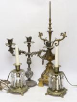 A pair of brass lustre drop candlesticks, lamp base and three branch candelabra, 59cm high