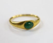 A Roman high carat yellow metal and single stone cabochon emerald set ring, size L, gross weight 3.7