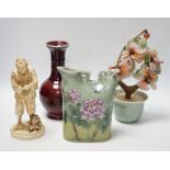 A Chinese flambé vase, famille rose jug, celadon plant pot and a Japanese porcelain figure,