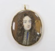 A 19th century yellow metal mounted oval pendant with inset watercolour on ivory miniature