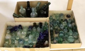 A collection of late 19th/early 20th century glass ink bottles, drink bottles and sauce bottles,