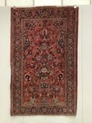 A Tabriz red ground rug, approximately 220 x 136cm