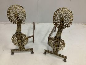 A pair of cast iron and pierced brass firedogs, height 64cm