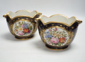 A pair of 19th century Paris porcelain cache pot hand painted with flowers and gilded decoration,