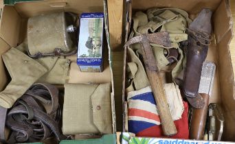 A collection of militaria including a union flag, gunners sight, camouflage webbing, a water bottle,