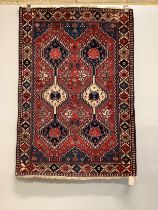 A Caucasian style red ground rug, 146 x 100cm