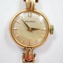 A lady's 9ct gold Jaeger LeCoultre manual wind wrist watch, on an associated 9ct gold bracelet,