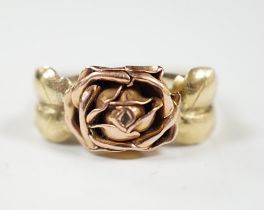 A two colour 585 flower head ring, with leaf shoulders, size P/Q, 3 grams.