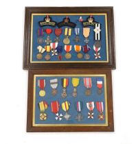 Twenty-seven medals and awards mounted in oak frames, including; French 1939-45 War Medal, Poland