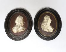 After Isaac Gosset, a pair of oval cream glazed terracotta portrait plaques of George II and