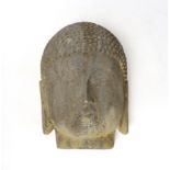 A reconstituted stone model of Buddha’s head, 25cm