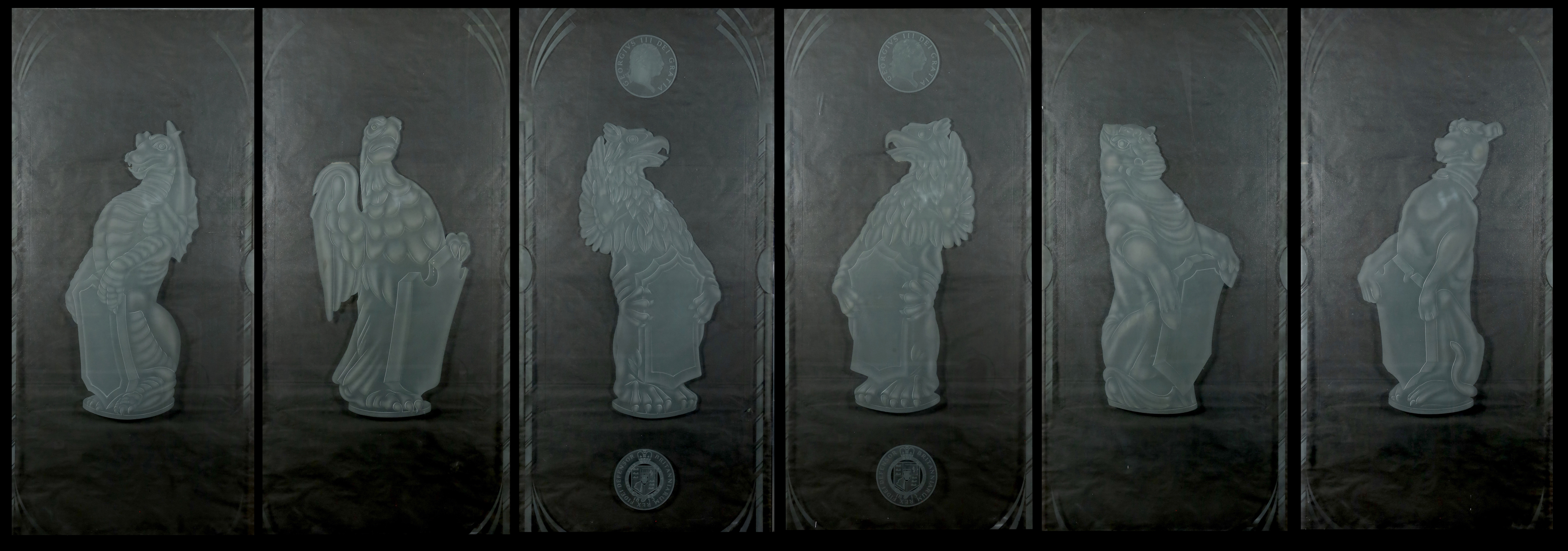 A set of six large cut and etched glass door panels each engraved with heraldic beasts, two with