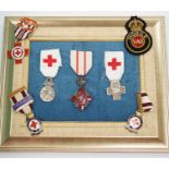 A collection of British Red Cross, medals, badges and memorabilia including a brass plaque,