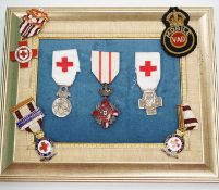 A collection of British Red Cross, medals, badges and memorabilia including a brass plaque,