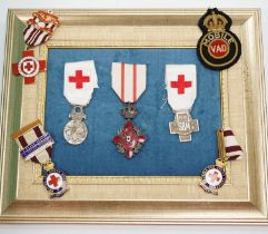 A collection of British Red Cross, medals, badges and memorabilia including a brass plaque,