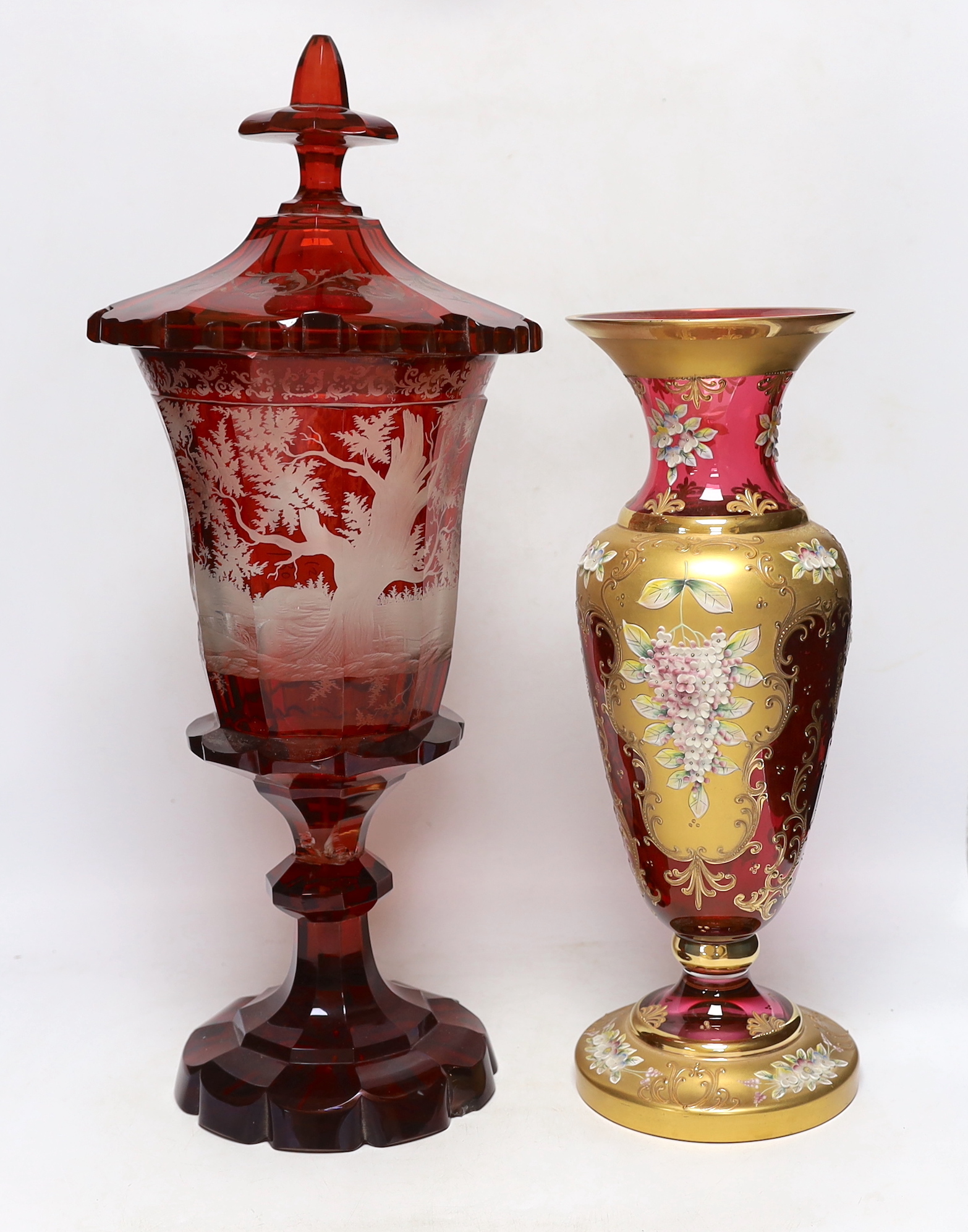 A late 19th century Bohemian ruby flashed and wheel engraved glass vase and cover, 52cm high and a