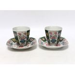 A pair of Chinese Qianlong famille rose octagonal cups and saucers, with panelled floral decoration,