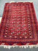 A Bokhara red ground rug, 210cm x 146cm