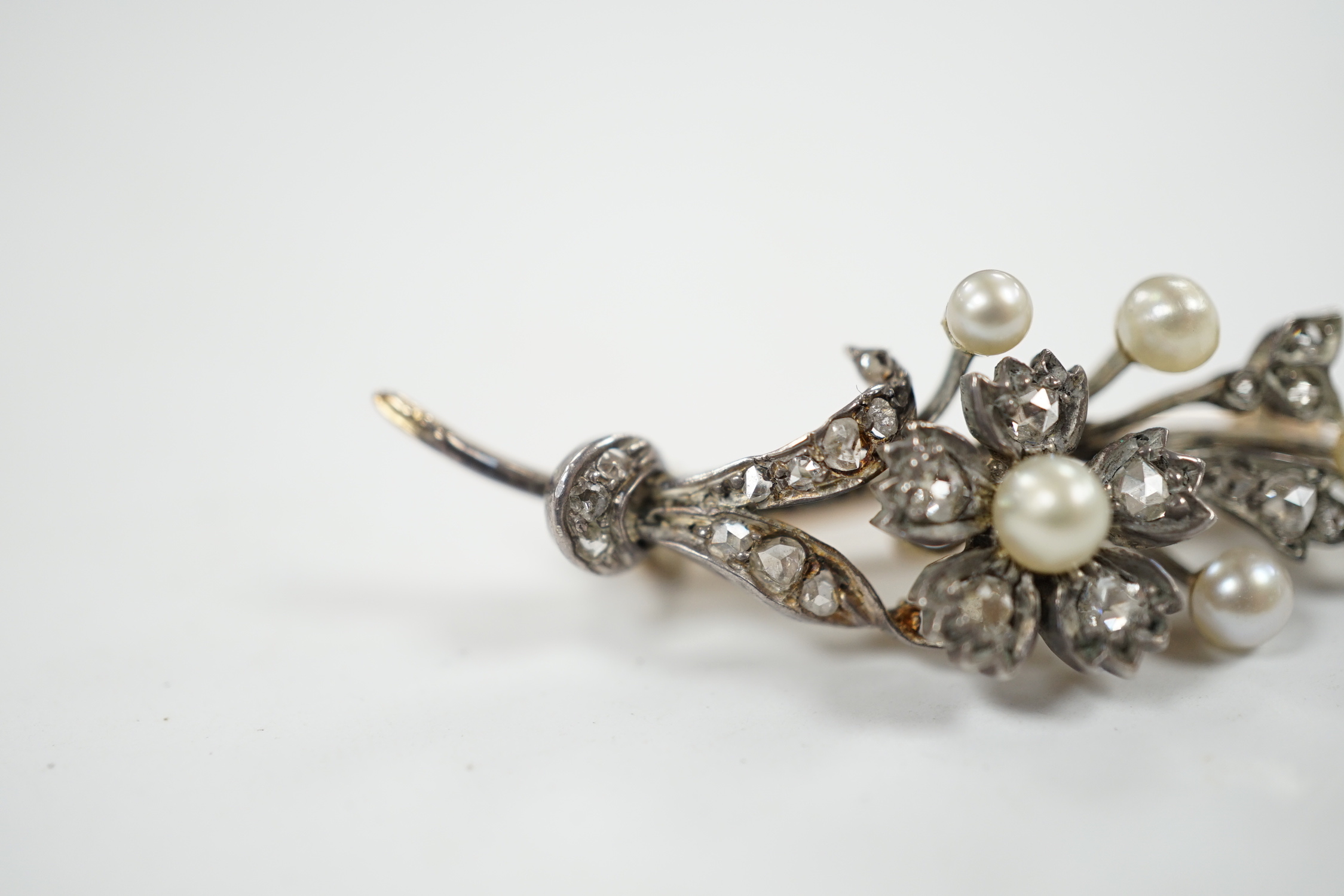 A cased Victorian yellow metal, seed pearl and rose cut diamond set foliate spray brooch, 39mm, - Image 2 of 7