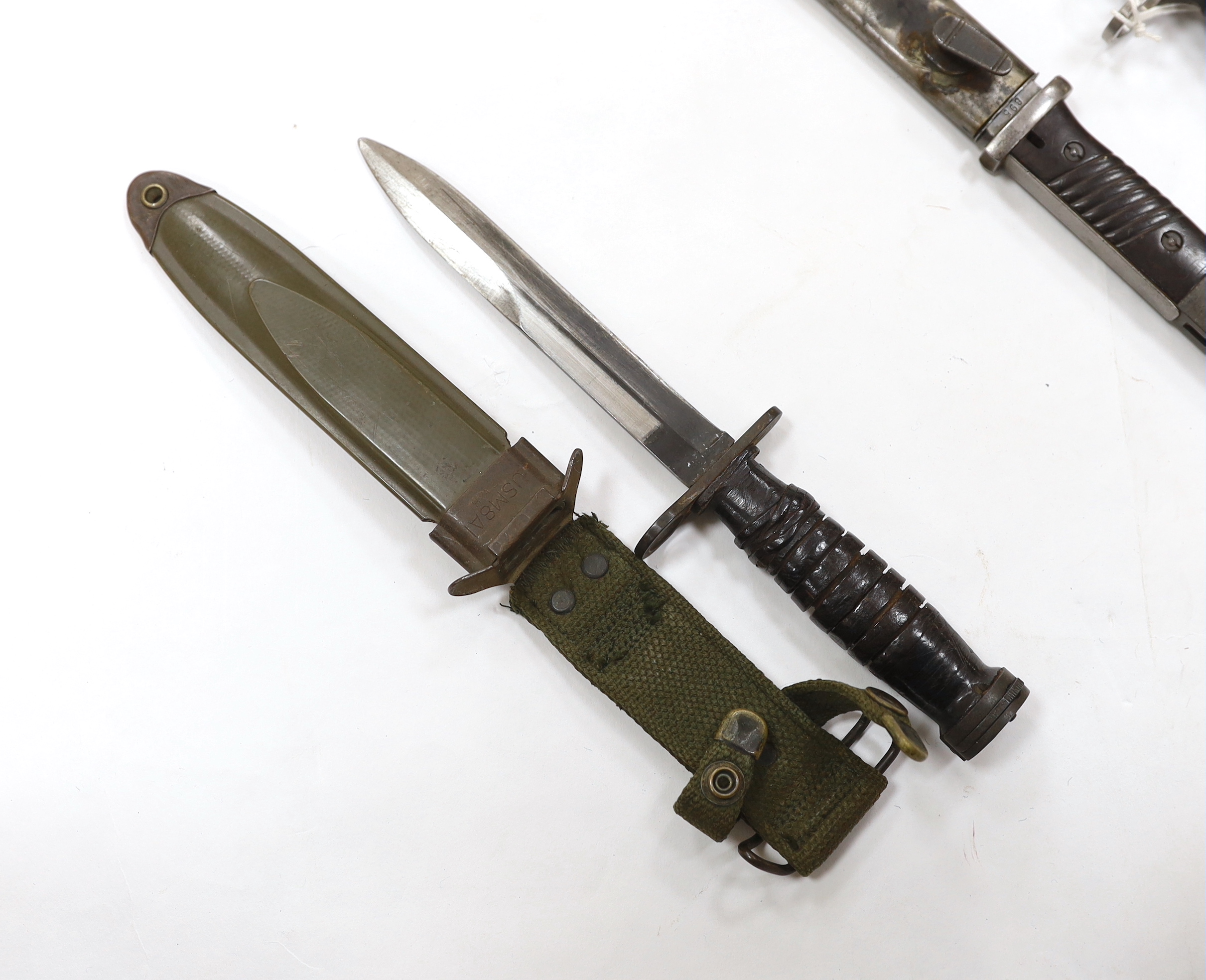 Four bayonets; two Mauser bayonets in scabbards, an American M8A1 carbine bayonet in a scabbard, and - Image 2 of 9