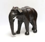 A leather elephant, stamped Liberty to the underside, 30cm wide