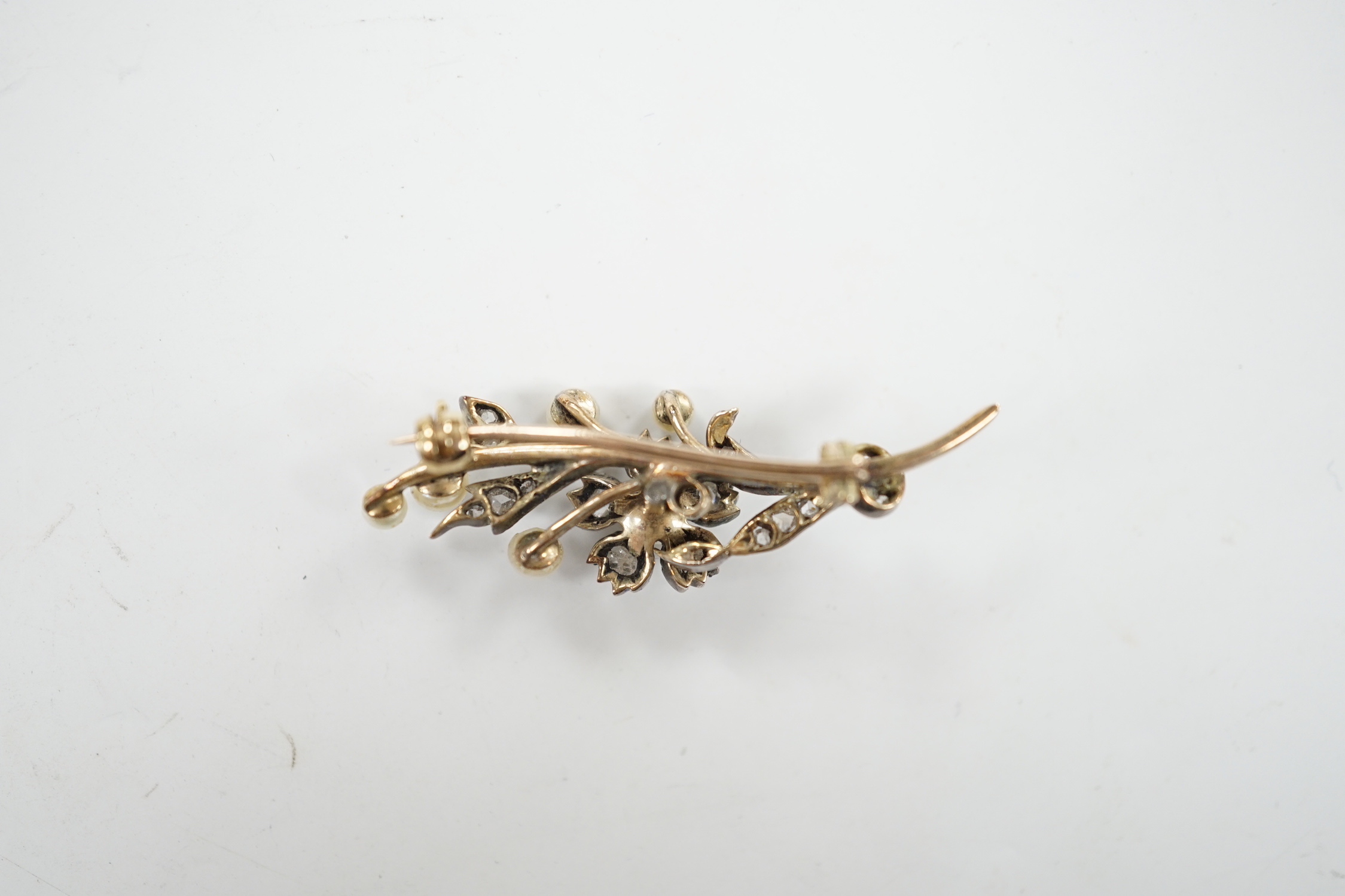 A cased Victorian yellow metal, seed pearl and rose cut diamond set foliate spray brooch, 39mm, - Image 6 of 7