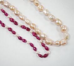 A modern cultured pearl and polished ruby? bead necklace, with two stone diamond chip set 750 clasp,