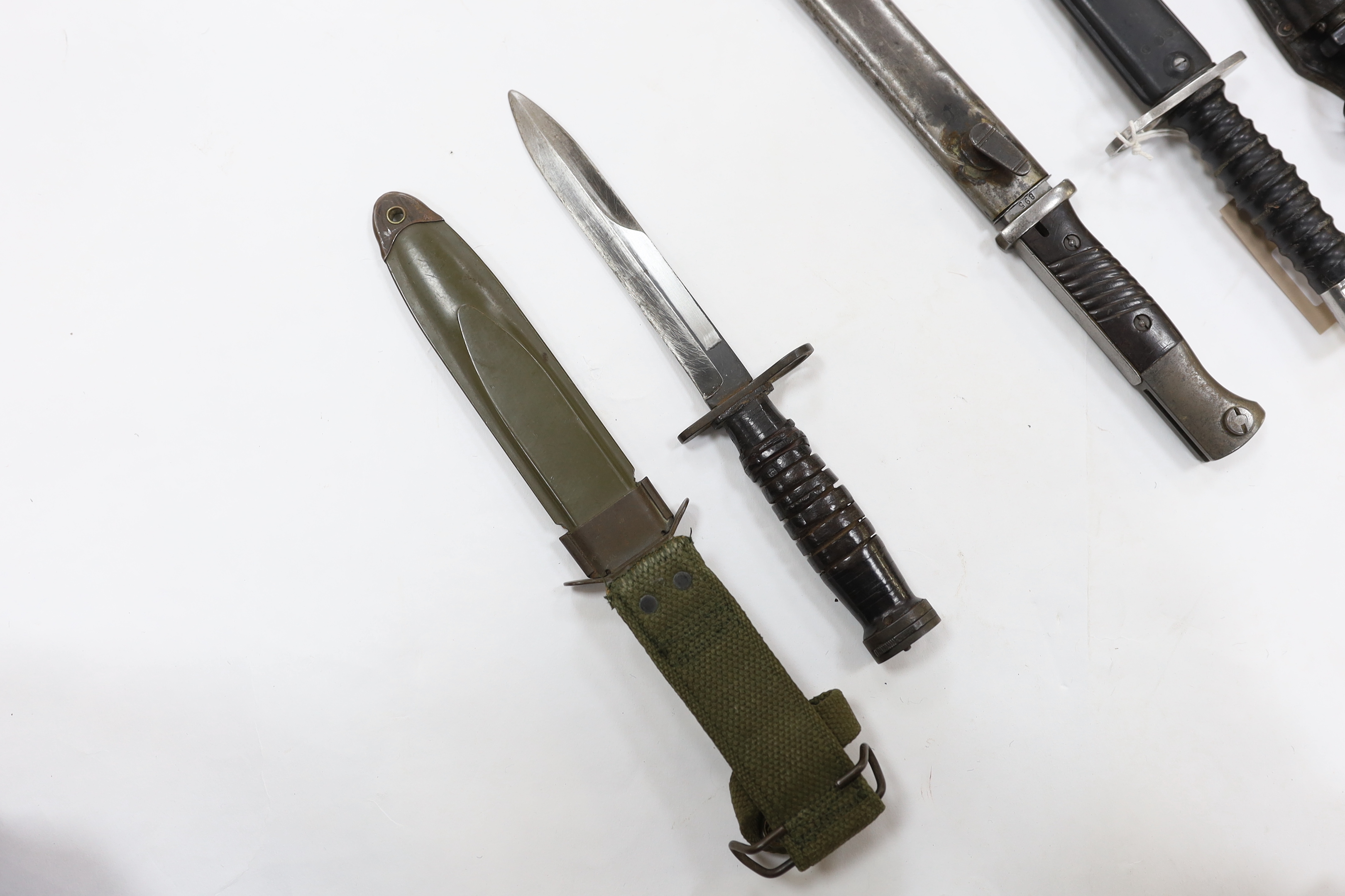 Four bayonets; two Mauser bayonets in scabbards, an American M8A1 carbine bayonet in a scabbard, and - Image 3 of 9
